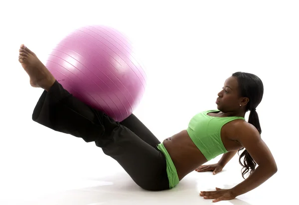 Young pretty hispanic african american woman exercising with fit ball — Stock Photo, Image