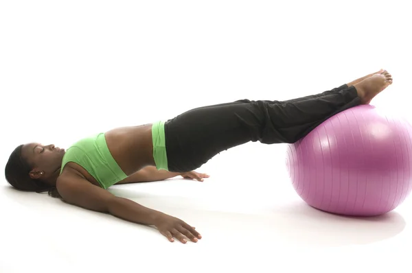 Young pretty hispanic african american woman exercising with fit ball — Stock Photo, Image