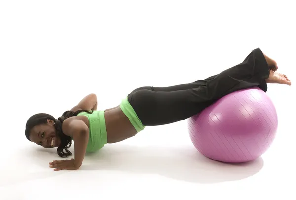 Young pretty hispanic african american woman exercising with fit ball — Stock Photo, Image