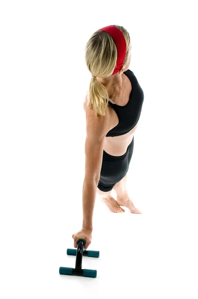 Woman exercising doing push up with fitness push up bar front view — Stock Photo, Image