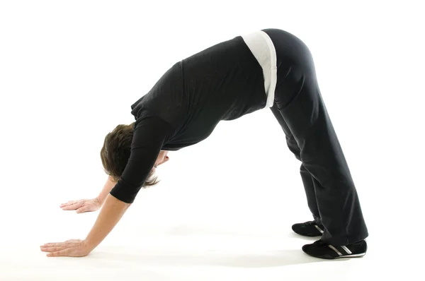 Mujer mayor de mediana edad mirando hacia abajo perro yoga posición — Foto de Stock