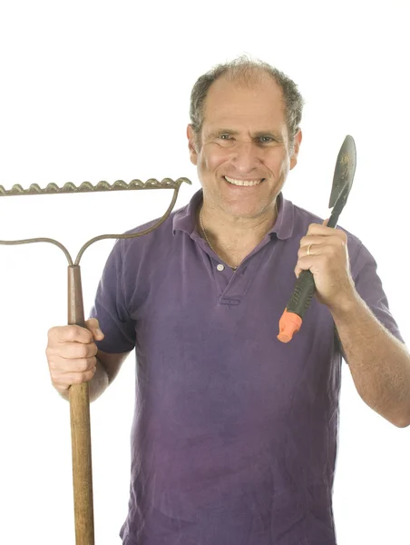 Middle age senior man gardener with spade and bow rake tools — Stock Photo, Image