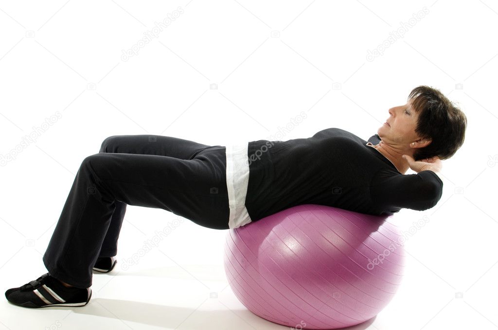 Woman using core training fitness ball for abdominal crunch sit-ups