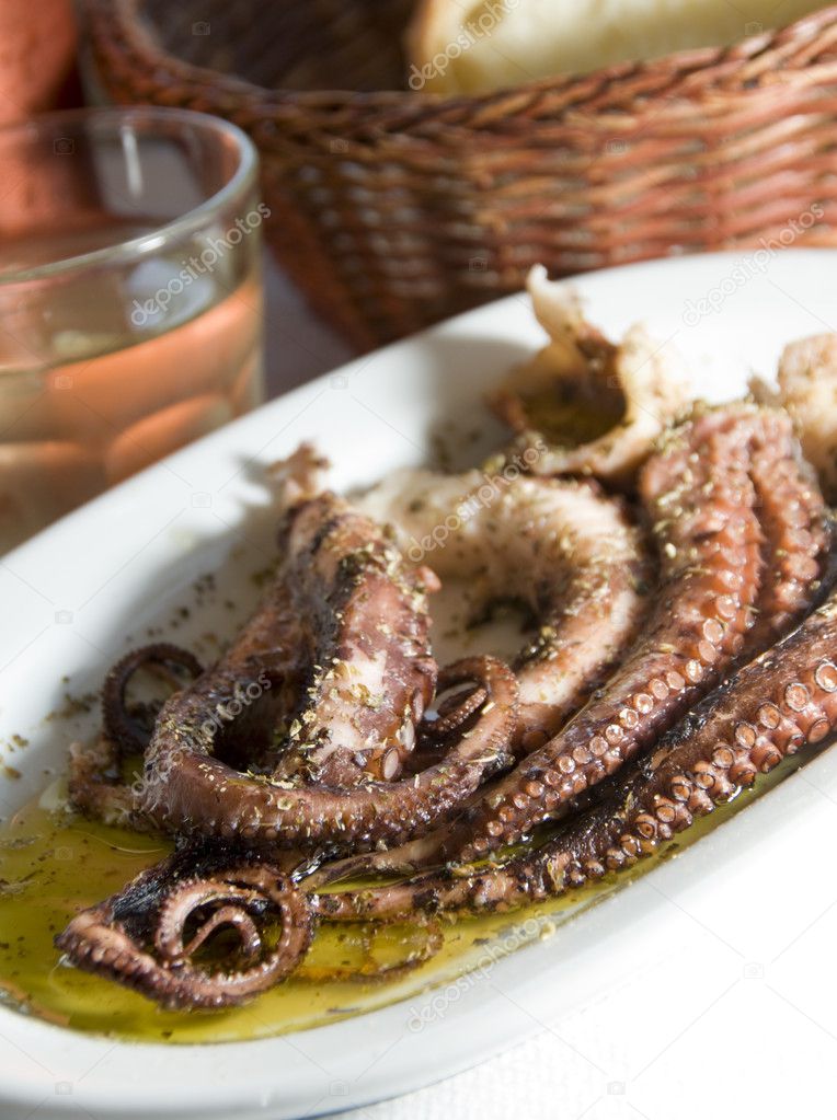 Picture of marinated octopus house wine metal carafe with crusty bread