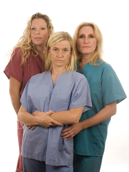 Three nurses in medical scrubs clothes — Stock Photo, Image