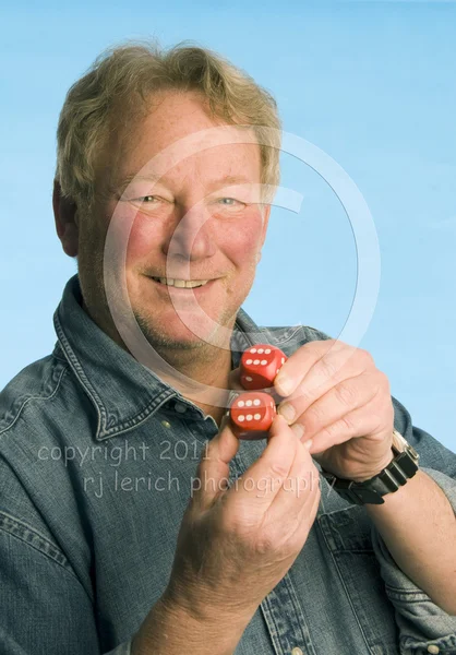 Handsome middle age senior man holding playing dice number box cars — Stock Photo, Image