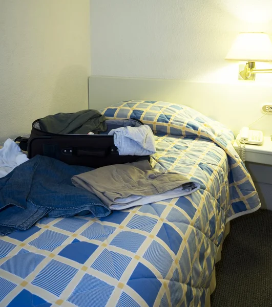 Hotel room with open suitcase — Stock Photo, Image