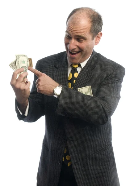 Homem meia idade rolando em dinheiro — Fotografia de Stock