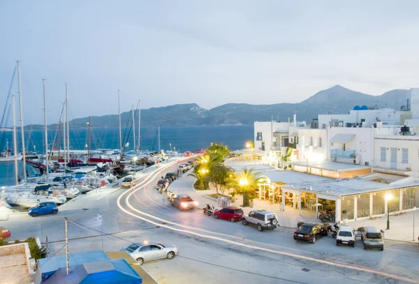 Adamas Milos Cyclades Greek island town at dusk waterfront harbor yachts and landscape scenery — Stock Photo, Image