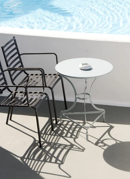 Chair with a table by the pool — Stock Photo, Image