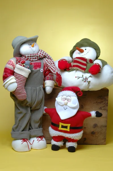 Man met geschenken, sneeuwpop en santa claus — Stockfoto