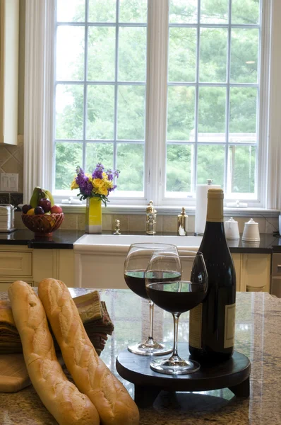 Kitchen island with wine baguettes — Stock Photo, Image