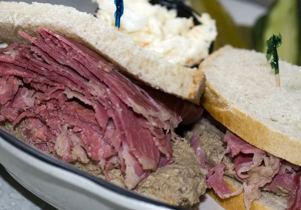 corn beef with chopped liver sandwich on rye bread