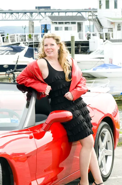 Sexy woman red sports car at yacht club — Stock Photo, Image
