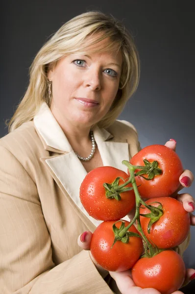 Woman with bunch of fresh ripe tomatoes — Stock Photo, Image