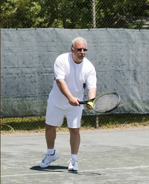 Middle age tennis player forehand on court — Stock Photo, Image