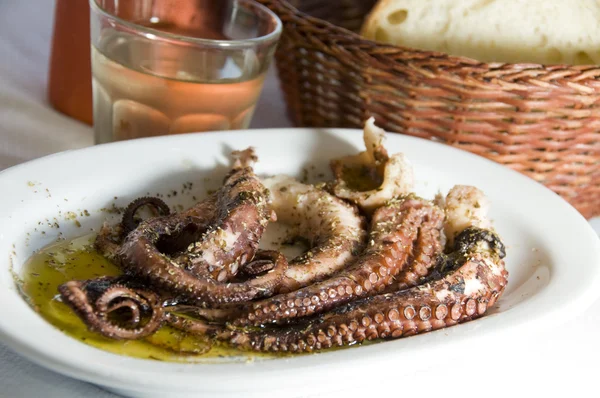 Marinated octopus with house wine Greek Island taverna specialty — Stock Photo, Image