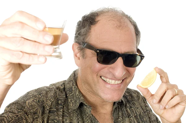 Middle age senior tourist male sun glasses drinking tequila sho — Stock Photo, Image