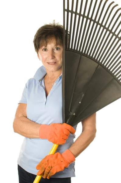 Female middle age senior gardener leaf rake — Stock Photo, Image