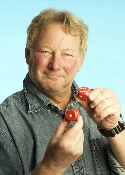 Handsome middle age man holding dice — Stock Photo, Image