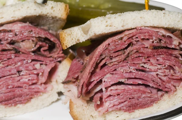 Corned beef pastrami combination sandwich rye bread pickles — Stock Photo, Image