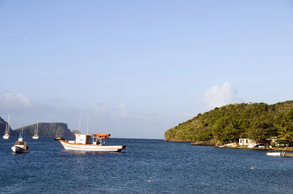 Native fishing boats bequia caribbean sea st. vincent and the grenadines with view of smaller grenadine islands — Stock Photo, Image