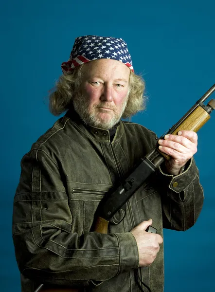 Handsome middle age man leather jacket rifle — Stock Photo, Image