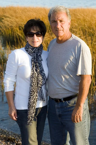 Happy middle age senior couple on beach — Stock Photo, Image