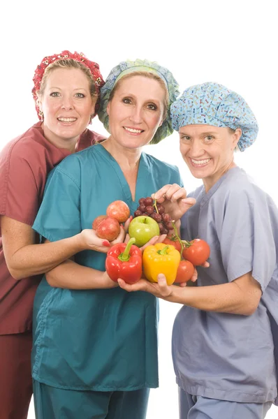 Group of nurses with healthy fruits and vegetables — Stock Photo, Image