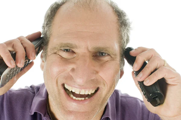 Apuesto de mediana edad hombre mayor representante de servicio de negocios feliz hablando en dos teléfonos al mismo tiempo —  Fotos de Stock