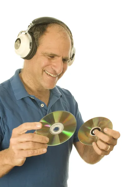 Middle age senior man listening to music through classic head phones — Stock Photo, Image