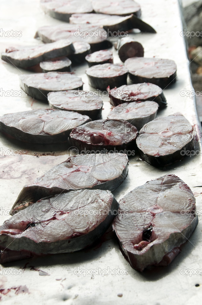 Fresh king fish fillets steaks on cutting board
