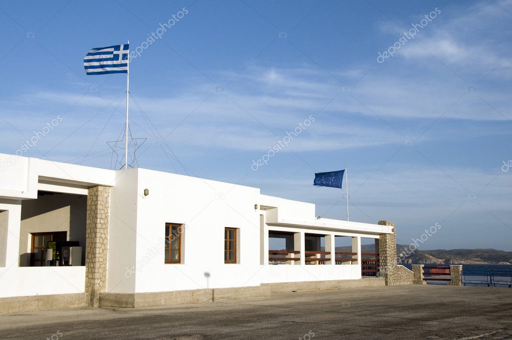 Milos Greek Island ferry port station white architecture national flag