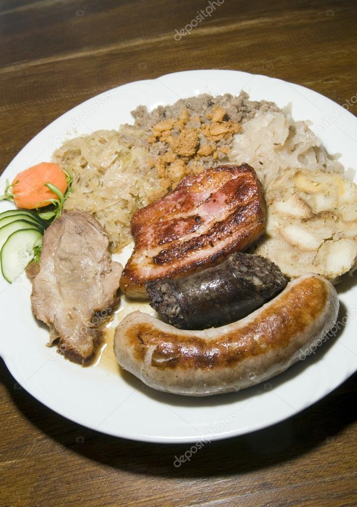 Typical food Slovenia black pudding fried sausage dried pork chops