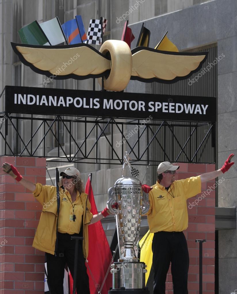 IMS workers holding Indy 500 Borg-warner trophy and greets fans on IMS Float during Indy 500 Festival Parade in Downtown Indianapolis.