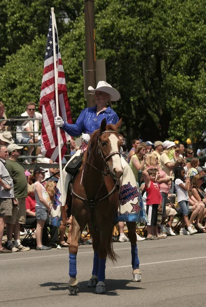 A Cowgirl holding a USA flag at the Indy 500 parade — Stock Photo, Image