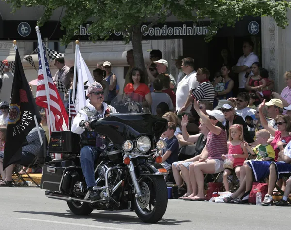 American Legion Riders Membro montando sua motocicleta com bandeiras no Indy 500 Parade Fotos De Bancos De Imagens