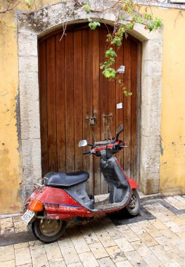 CHANIA,GREECE-OCTOBER 03:Old Scooter parked in front of old Greek House.October 03,2013 in Chania,Crete,Greece.