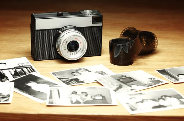 Alte Kamera neben unscharfen Schwarz-Weiß-Fotos Stockfoto