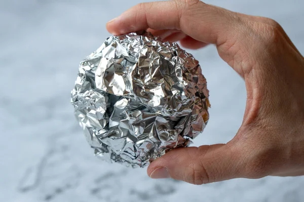 Wrinkled ball of aluminium foil, a material often used in the kitchen.