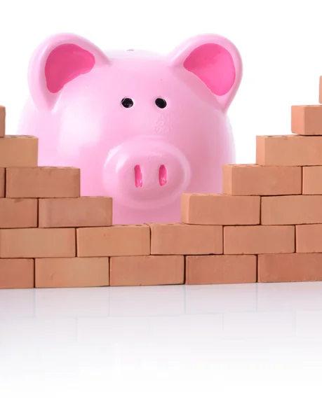 Piggy bank breaking down the walls of finance — Stock Photo, Image