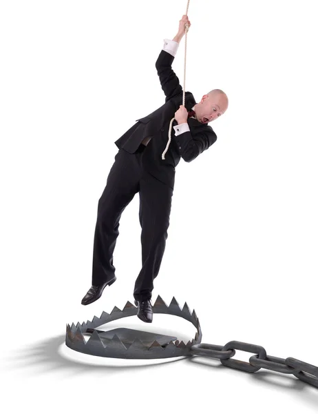 Businessman hanging on rope — Stock Photo, Image