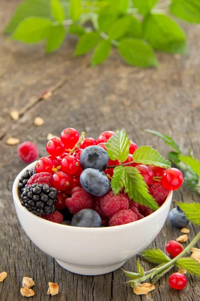 Assorted berries on wooden background (strawberries, raspberries, blackberries, blueberries) — Stock Photo, Image