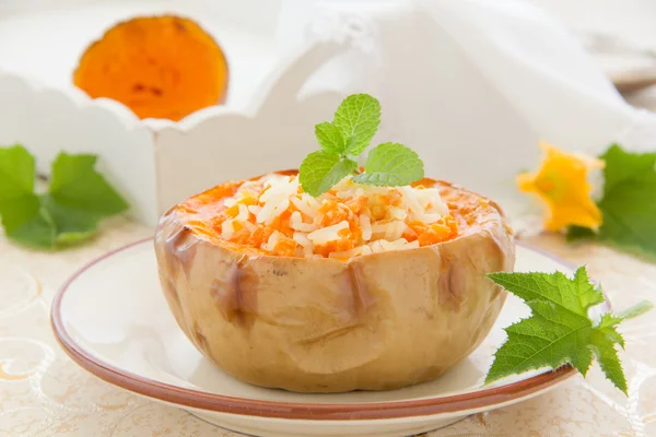 Rice porridge with pumpkin baked in a pumpkin. Selective focus. — Stock Photo, Image