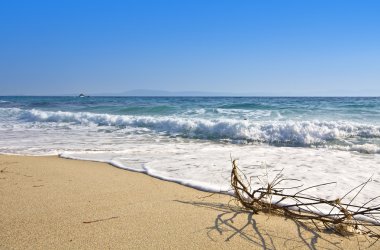 Sunny beach at the mediterranean coast in Greece clipart