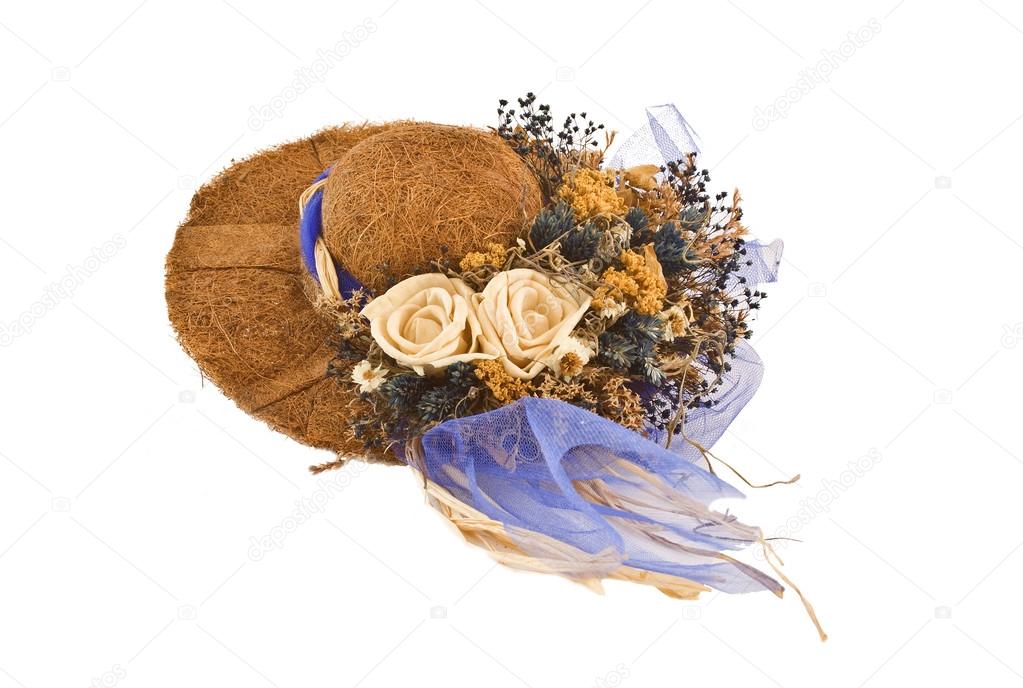 Decorative hat with fake flowers on top of it