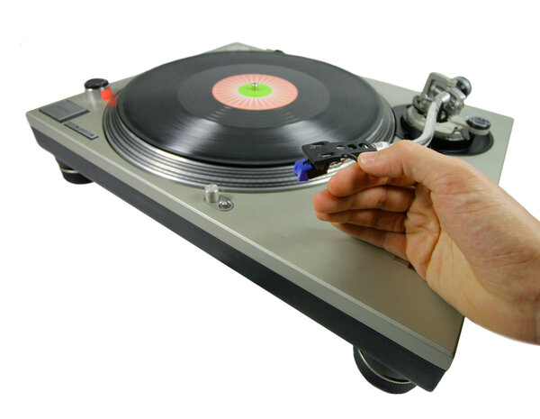 A hand putting a needle on a record