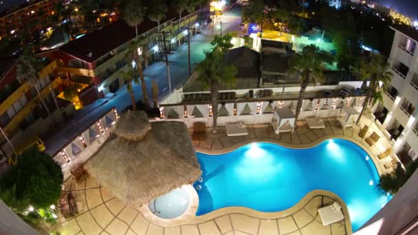 Timelapse at night looking down onto a luxury swimming pool in a boutique hotel — Stock Video