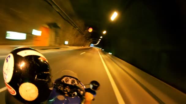 Shot off the back of a motorbike racing through tunnels — Stock Video