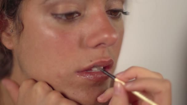 A model having her makeup applied before a shoot — Stock Video